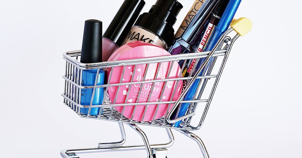 Miniature shopping cart filled with a variety of cosmetics on a white background.