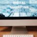 Contemporary office setup featuring digital marketing strategy on a computer screen, ideal for business technology themes.
